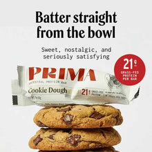 PRIMA Ancestral Protein Bar in Cookie Dough flavor with 21g grass-fed protein, shown unwrapped with two cookies stacked below