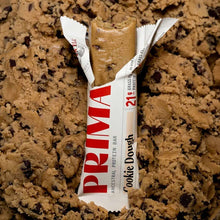 PRIMA Ancestral Protein Bar in Cookie Dough flavor, partially unwrapped, displaying 20g protein content on packaging.