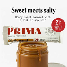 PRIMA Ancestral Protein Bar in Salted Caramel flavor with 21g grass-fed protein, shown unwrapped next to caramel sauce.