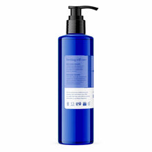 Blue bottle with black pump dispenser containing body lotion with product information and certification badges on white label