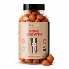 Bottle of TruHeight Bone Growth gummies with orange strawberry-flavored gummies visible inside and outside the clear containe