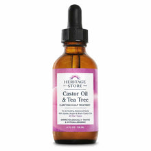 Amber glass bottle with black dropper cap and pink label reading "Heritage Store Castor Oil & Tea Tree" clarifying scalp trea