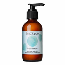 Dark amber glass bottle with black pump dispenser and white label featuring "Mad Hippie Cream Cleanser" text and blue waterco