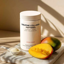 Cylindrical white container of Creatine Collagen Peptides powder with mango flavor next to fresh mango slices and small bowl