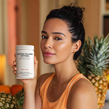 Woman holding white Codeage Creatine Collagen Peptides supplement container in orange tank top.