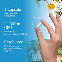Hand holding a white probiotic capsule against blue background with daisies and nature imagery.