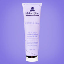 White tube of Naked Bee Embracing Aging SPF 30 Daily Sheer Defense Moisturizer with purple text on purple background.