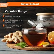 Ginger root, brewed ginger tea in glass cup, fresh mint leaf, and lemon slices on wooden board.