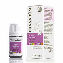 Small dark glass bottle with white cap labeled "Pranarom Gumm Dropps" next to white box with purple band and product informat