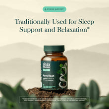 Gaia Herbs Kava Root supplement bottle with green cap sitting in soil against a blurred landscape background.