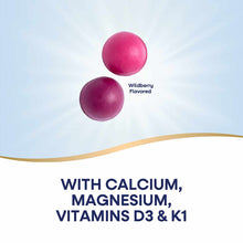 Two pink and dark purple spherical gummies labeled wildberry flavored on light blue background with text listing calcium, mag