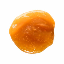 Single orange gel packet containing magnesium supplement with visible bubbles on translucent surface.