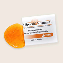 LivOn Lypo-Spheric Vitamin C packet next to an orange sphere with water droplets on beige background.
