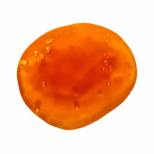 Orange spherical gel capsule with visible bubbles on surface.