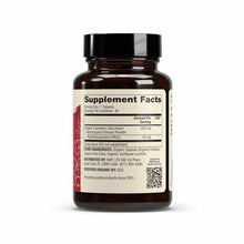 Dark amber glass bottle with black cap containing organic cranberry supplement capsules and supplement facts label.