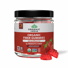 Glass jar with black lid containing red strawberry-flavored gummies and label reading "Organic India Organic Fiber Gummies" w