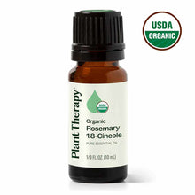 Small amber glass bottle with black cap containing rosemary essential oil labeled Plant Therapy, with USDA Organic certificat