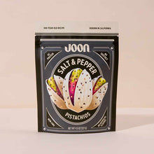 Joon brand salt and pepper pistachios in a black pouch with illustrated pistachio design and product details.