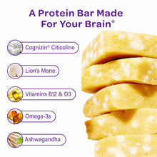 Stack of yellow protein bars with white pieces, labeled with ingredients including Cognizin Citicoline, Lion's Mane, Vitamins