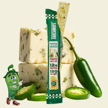 Takeaways Pepper Jacked puffed snack bar with 12g protein, displayed with fresh green peppers and puffed rice cakes.