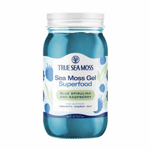 Clear glass jar with white metal lid containing blue sea moss gel, labeled "True Sea Moss" with blue spirulina and raspberry