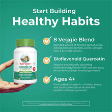 Bottle of MaryRuth's Super Greens Gummies with green cap held in hand against teal background with product information text.