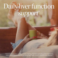 Person holding a small green cup outdoors with text overlay about liver function support.