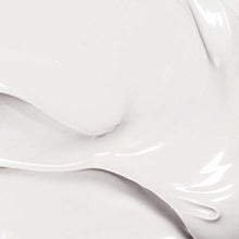 Creamy white lotion with smooth, glossy texture and swirled application streaks.