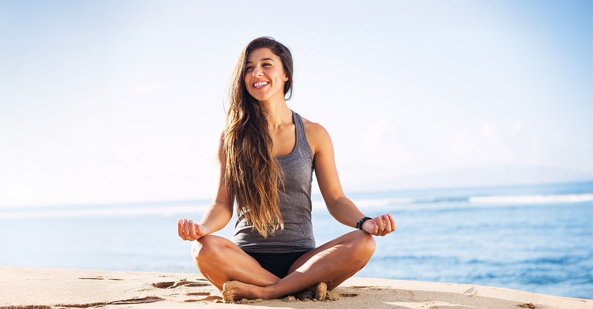 A happy woman meditating outdoors