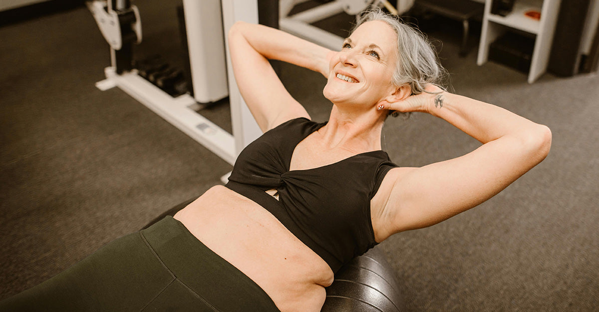 older woman doing assisted sit-ups