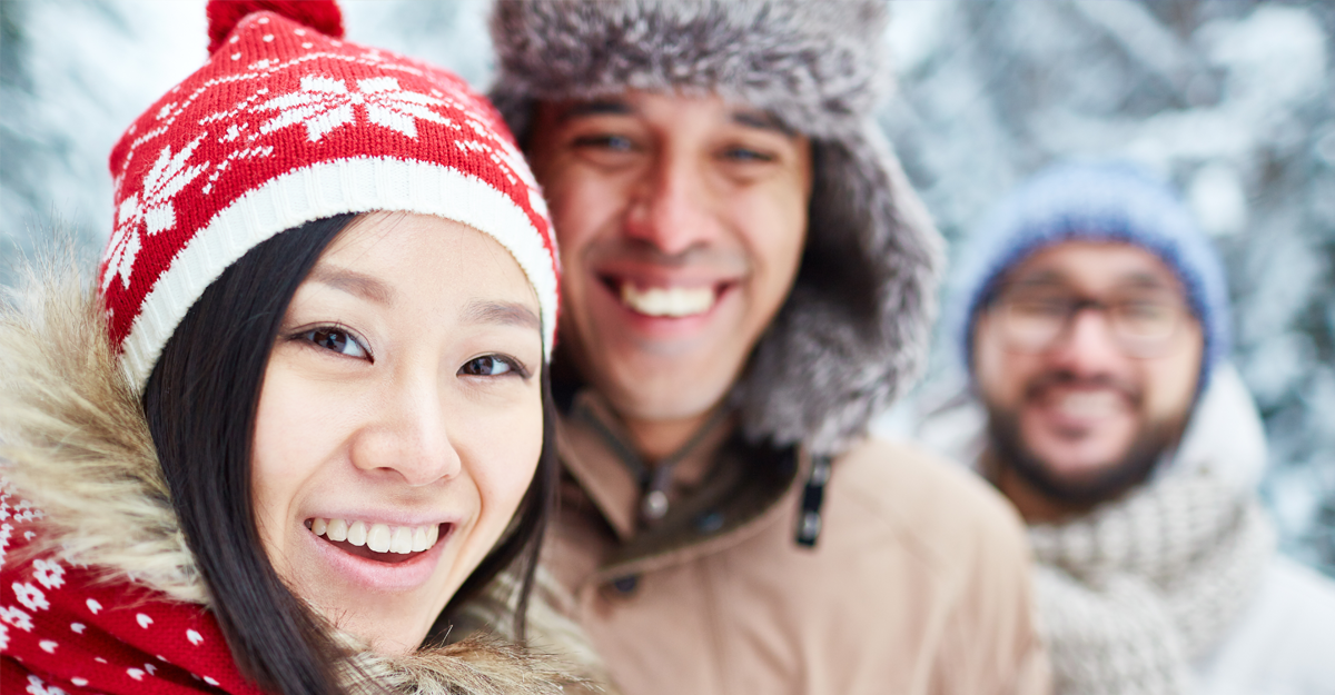 People smiling outdoors in snowy weather