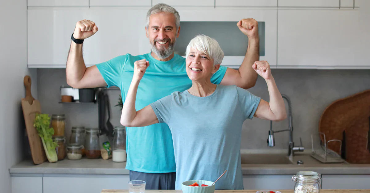 2 seniors flexing and smiling into camera