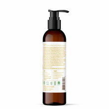 Amber glass bottle with black pump dispenser and beige label containing product information and ingredient list.