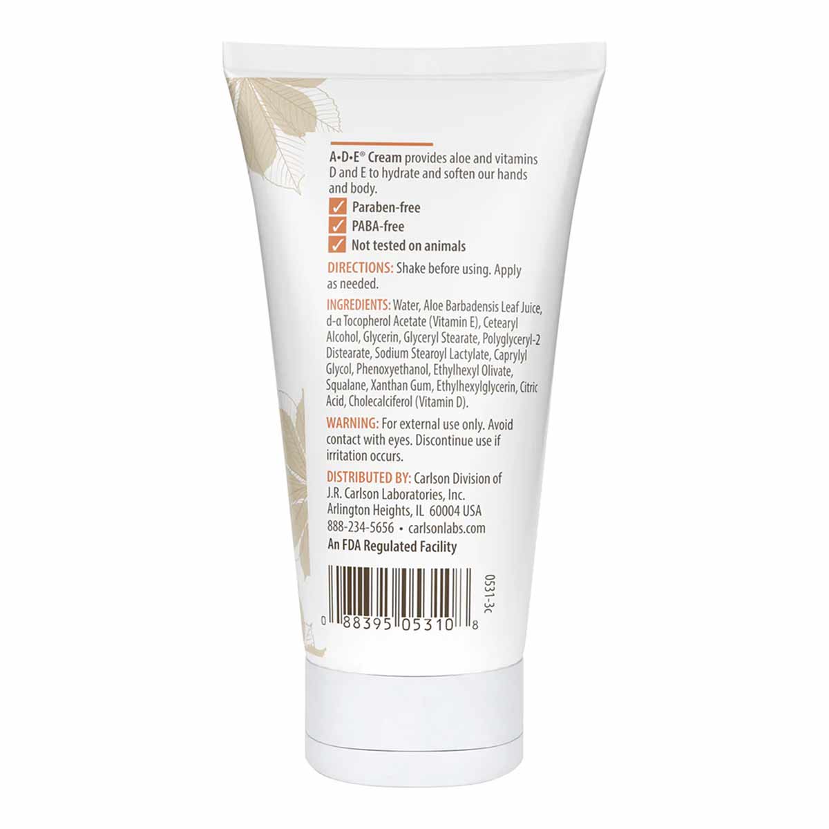 White tube of ADE Cream by Carlson Labs with product information and decorative leaf design on packaging.