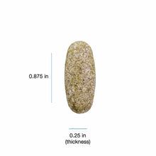 Tan and white speckled oval capsule supplement measuring 0.875 inches in length and 0.25 inches in thickness.