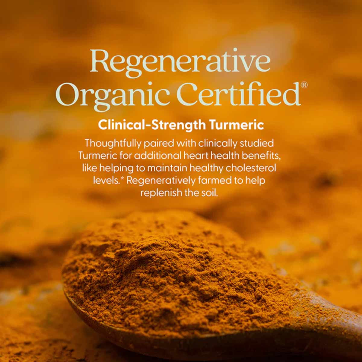 Wooden spoon holding turmeric powder with scattered powder on blurred golden background.
