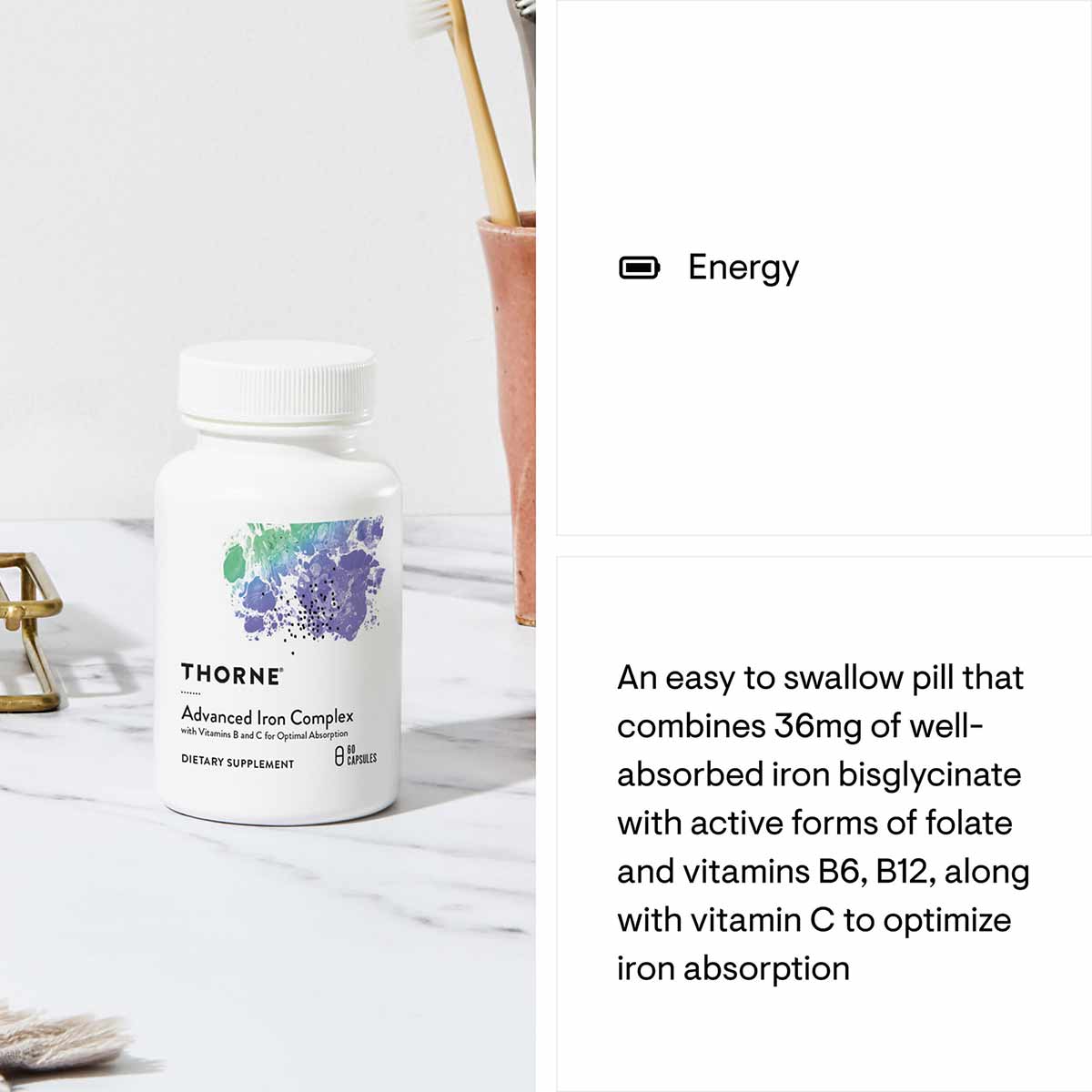 White bottle of Thorne Advanced Iron Complex dietary supplement with colorful logo on marble surface.