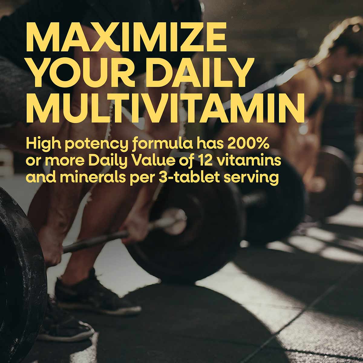 Bottle of Alive Max3 Daily Multi-Vitamin supplement with yellow text describing the formula benefits on a blurred gym backgro