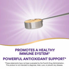 Stainless steel measuring scoop filled with tan-colored powder on purple background.