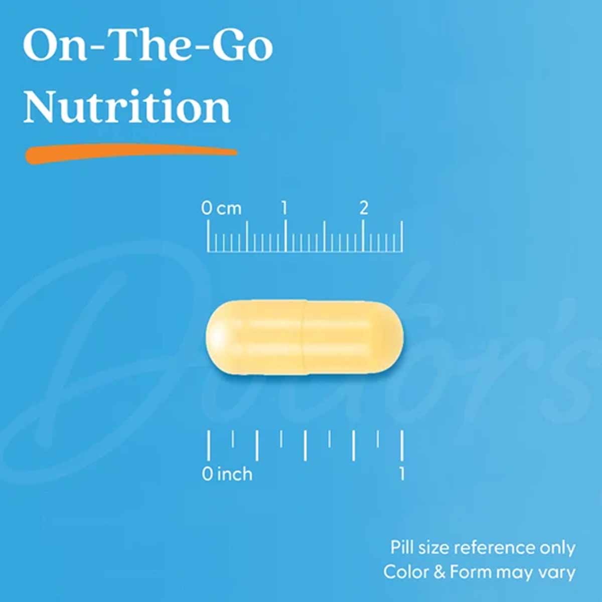 Yellow oval supplement capsule shown with centimeter and inch scale rulers on blue background.