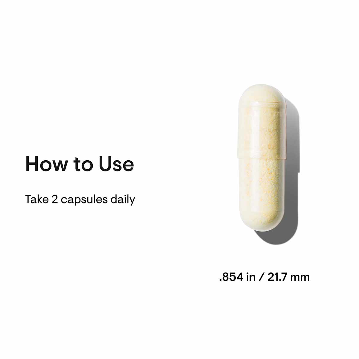 Cream and yellow capsule with usage instructions stating "Take 2 capsules daily," measuring 0.854 inches or 21.7 mm.
