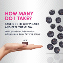 Hand holding a small dark brown soft chew with acai berries displayed on the right side.