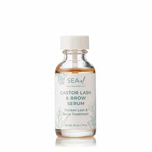 A small clear glass bottle with a white cap holds amber serum and a white label with teal text and seaweed illustrations.