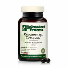 Dark brown glass bottle of Standard Process Chlorophyll Complex dietary supplement with cream-colored cap and two black softg