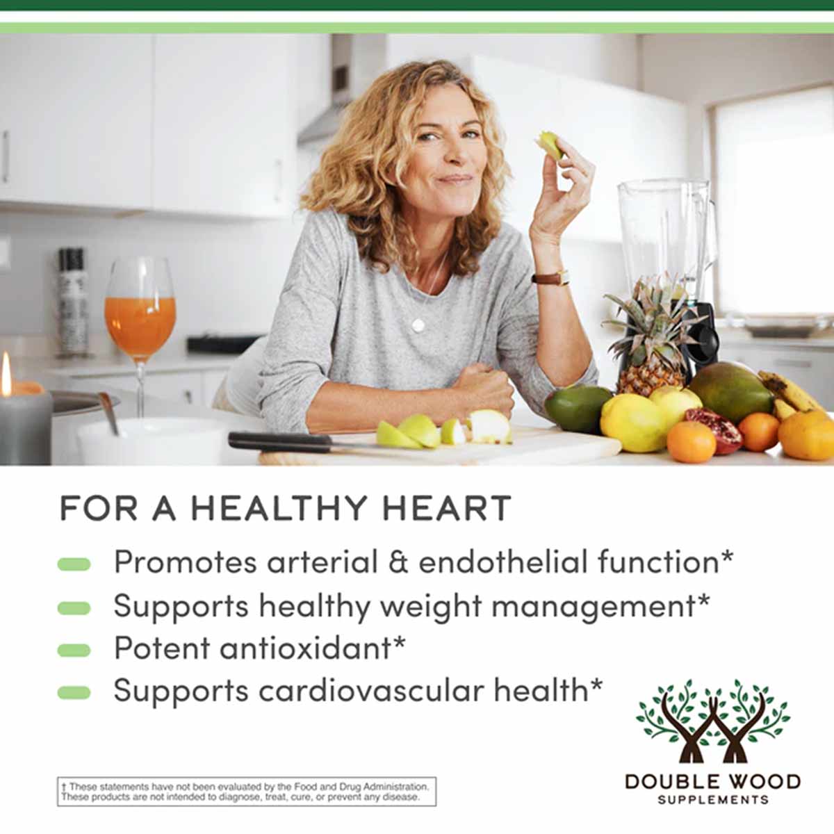 Woman in kitchen holding citrus fruit with fresh produce and juice glass on counter.