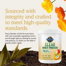 Garden of Life Clear Whey Protein powder container with mango flavor, surrounded by yellow and orange flowers and green leave