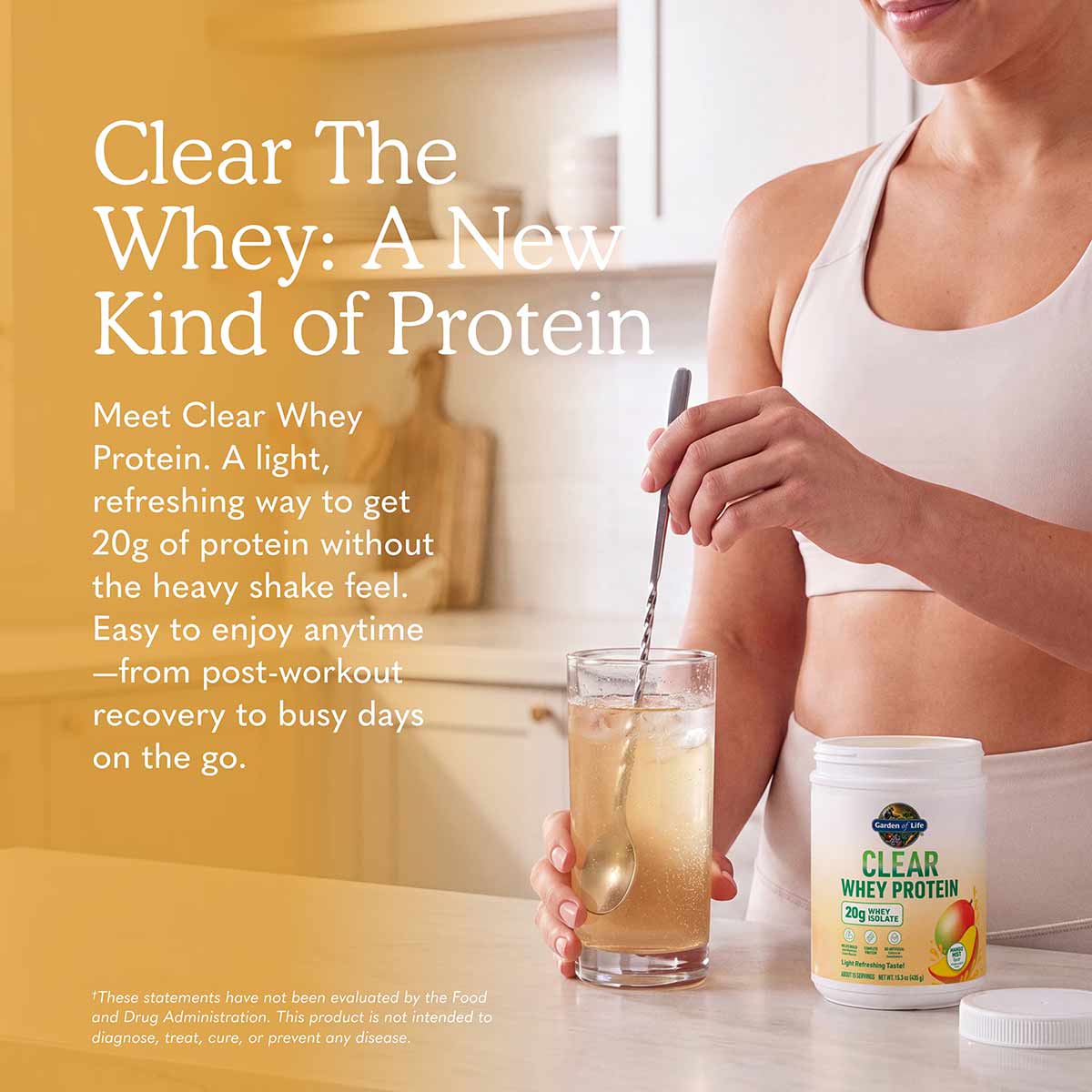 Woman holding glass of clear protein drink with Garden of Life Clear Whey Protein container on table beside her.