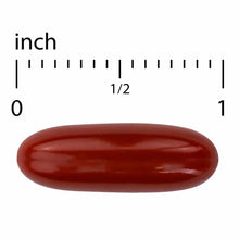 Dark red oval softgel capsule shown next to ruler measuring approximately one inch in length.
