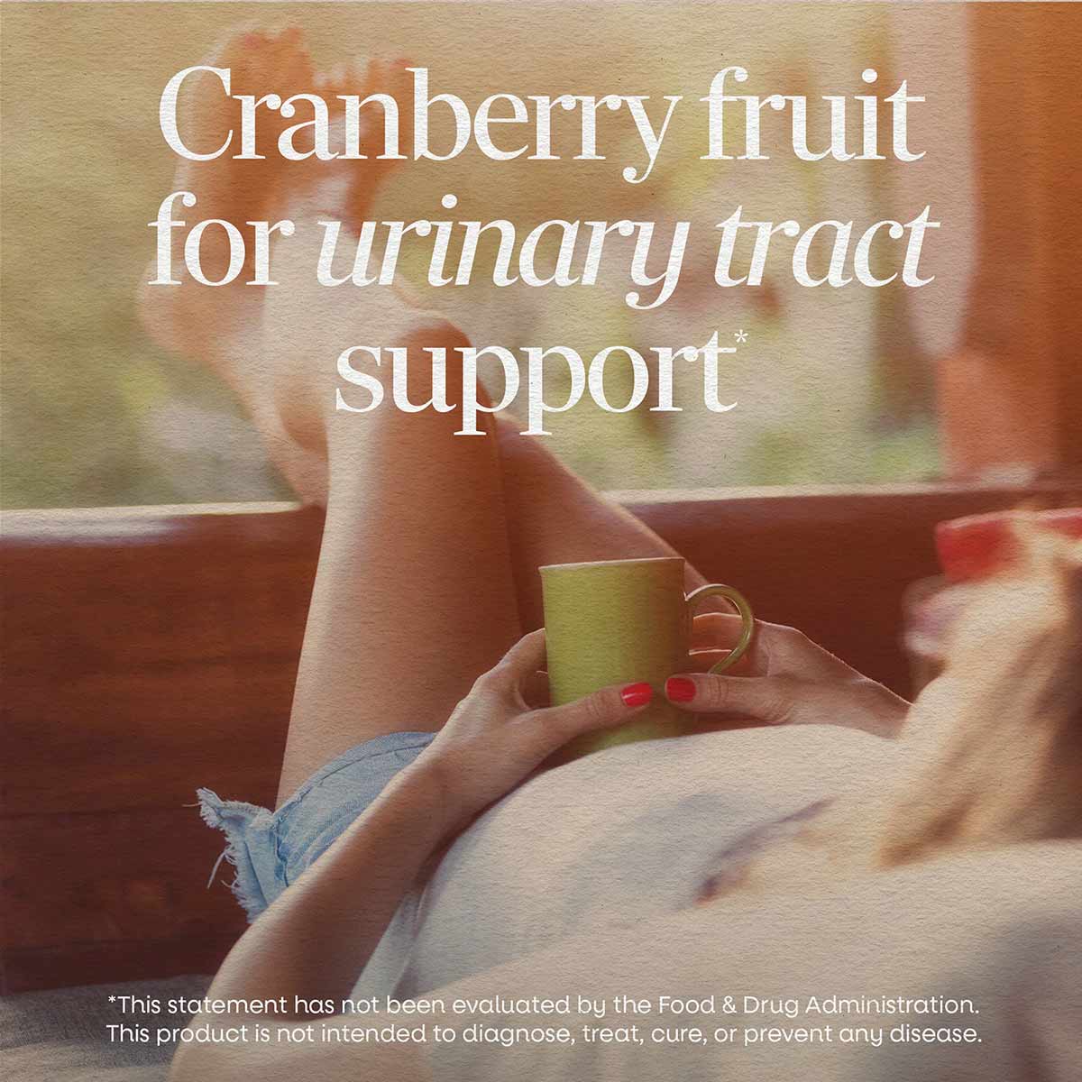 Person holding a yellow mug with text overlay about cranberry fruit for urinary tract support.