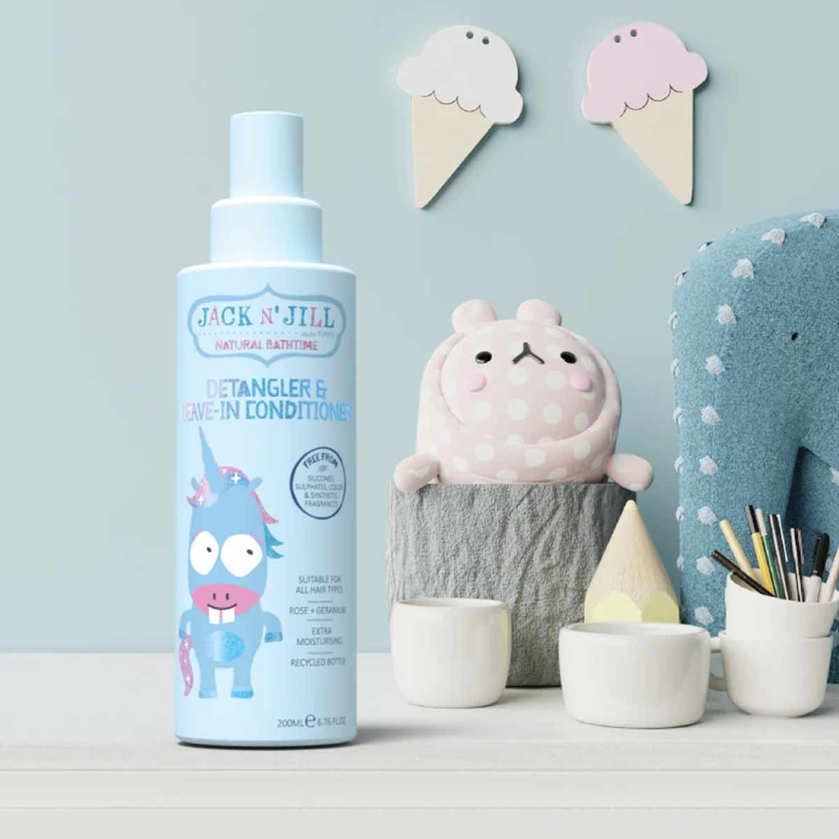 Jack N' Jill Detangler & Leave-In Conditioner spray bottle with cartoon character label next to decorative ice cream and clou